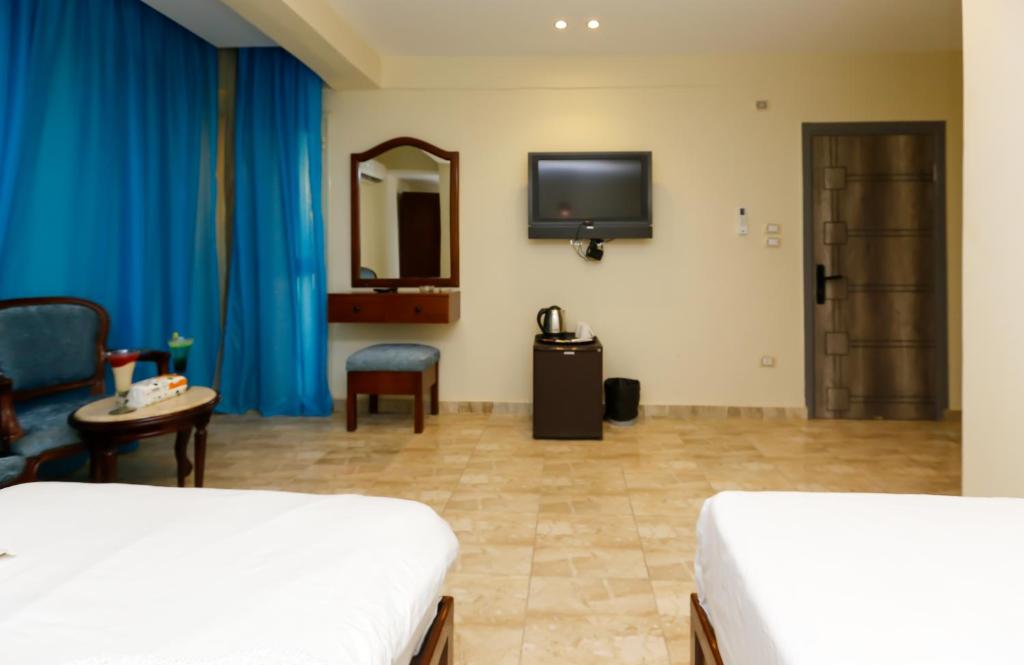 Postel nebo postele na pokoji v ubytování Giza Pyramids Inn