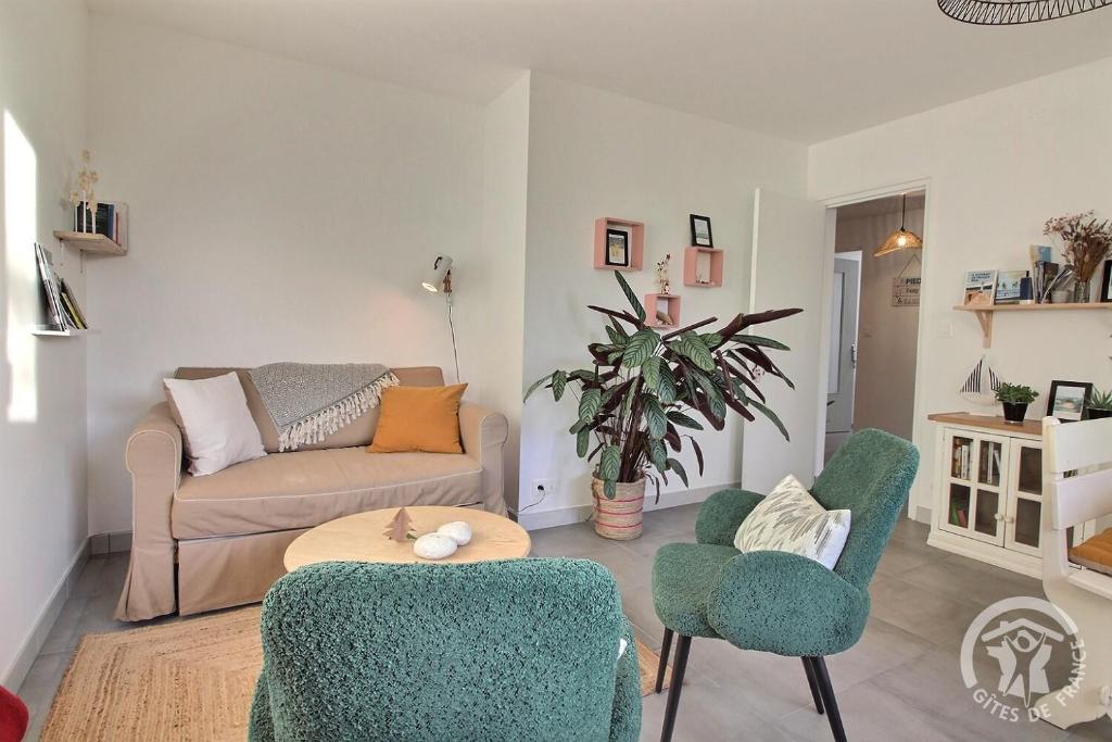 a living room with a couch and two chairs at Chez mathieu et gaelle in Binic-Etables-sur-Mer