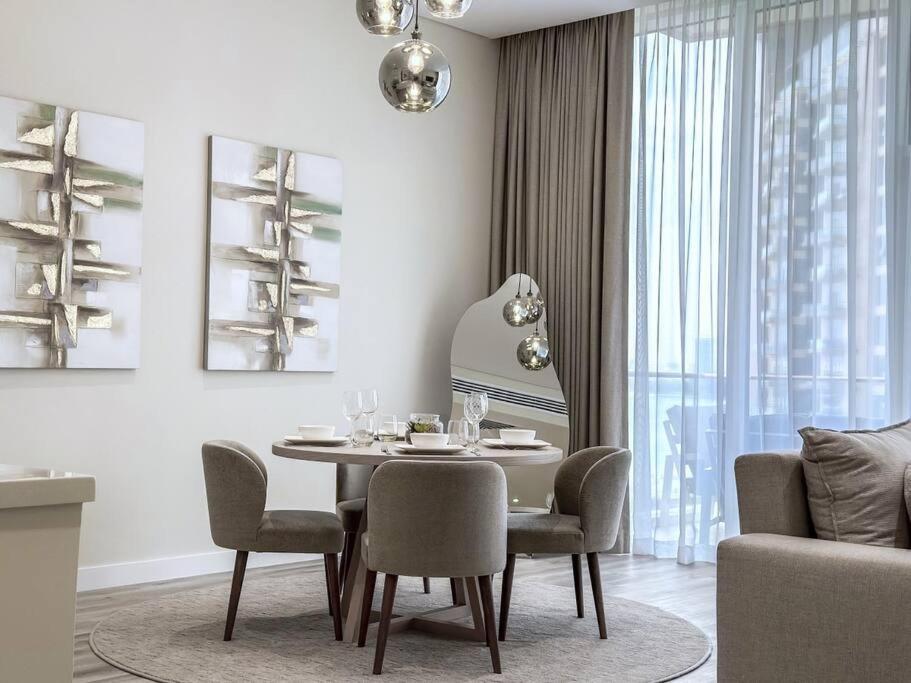a dining room with a table and chairs at Fantastic flat in TiaraResidence in Dubai