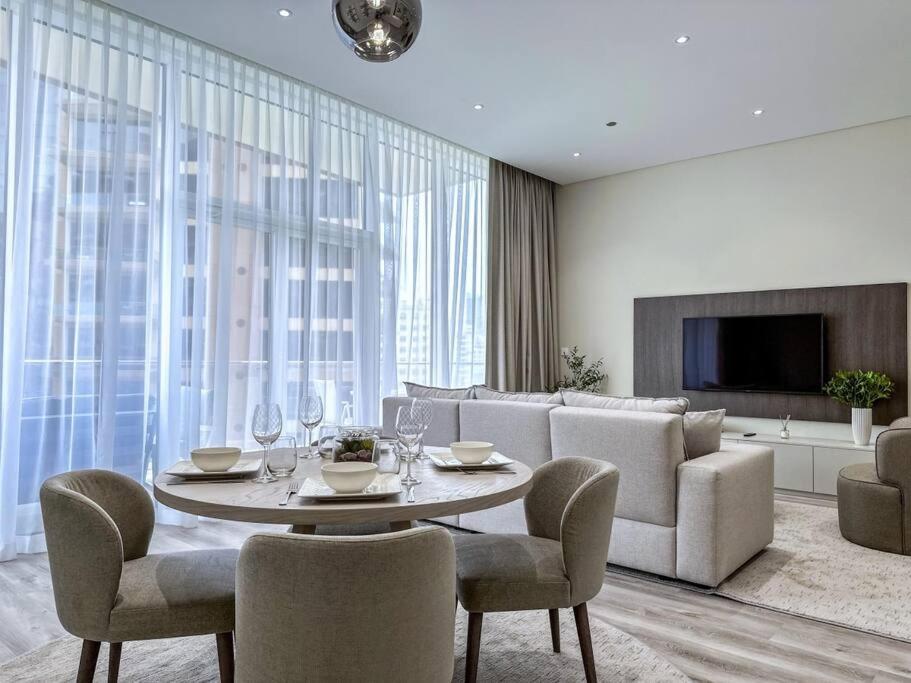a living room with a table and a couch at Fantastic flat in TiaraResidence in Dubai