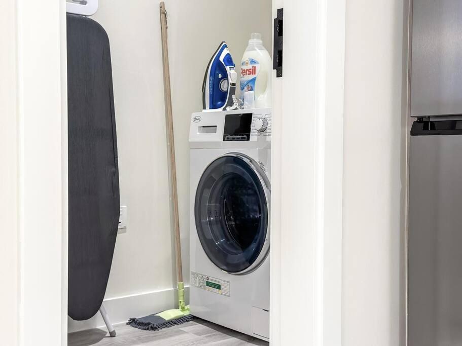 a washer and dryer in a room at Fantastic flat in TiaraResidence in Dubai