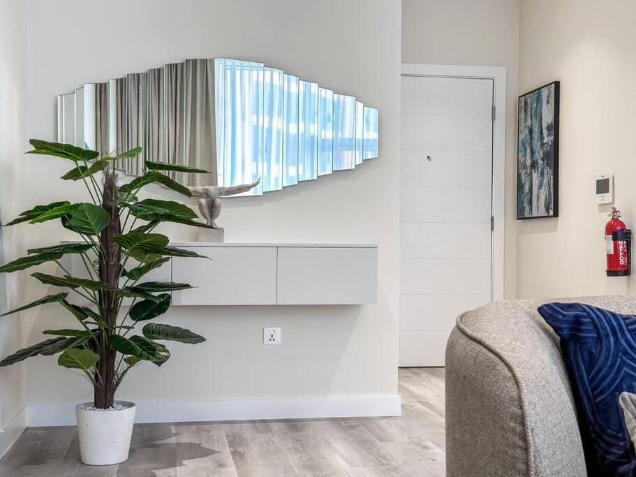 a living room with a plant and a couch at Fantastic flat in TiaraResidence in Dubai