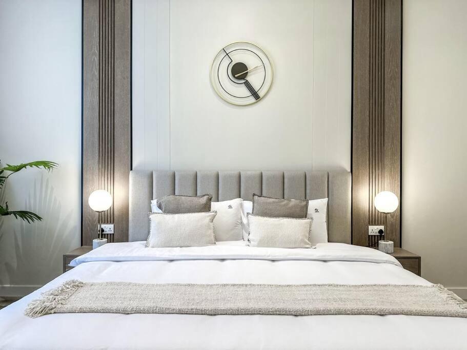 a bedroom with a large bed with a large headboard at Fantastic flat in TiaraResidence in Dubai