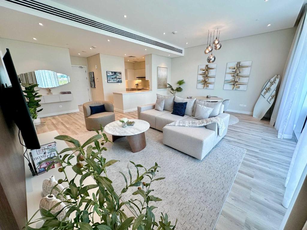a living room with a couch and a table at Renovated Marina view apartment in Oceana in Dubai