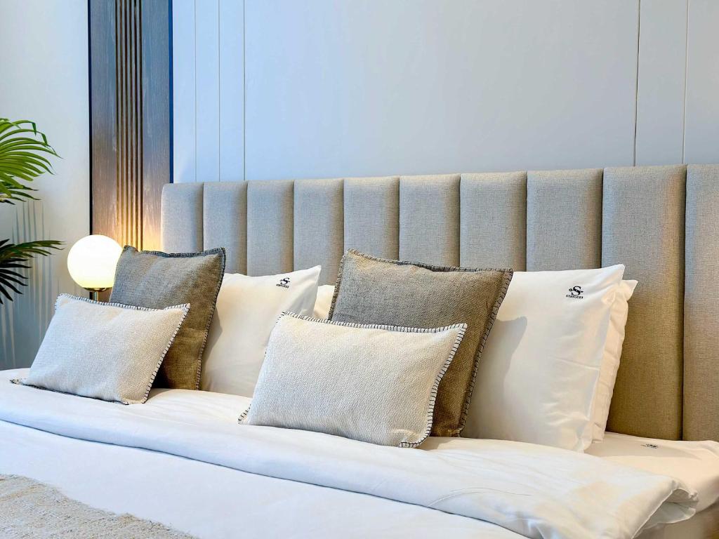 a couch with many pillows on it at Renovated Marina view apartment in Oceana in Dubai