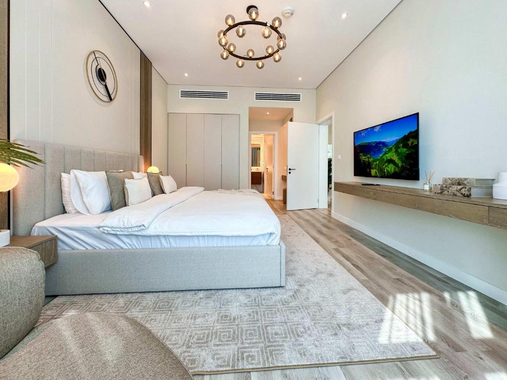 a bedroom with a bed and a tv on a wall at Renovated Marina view apartment in Oceana in Dubai