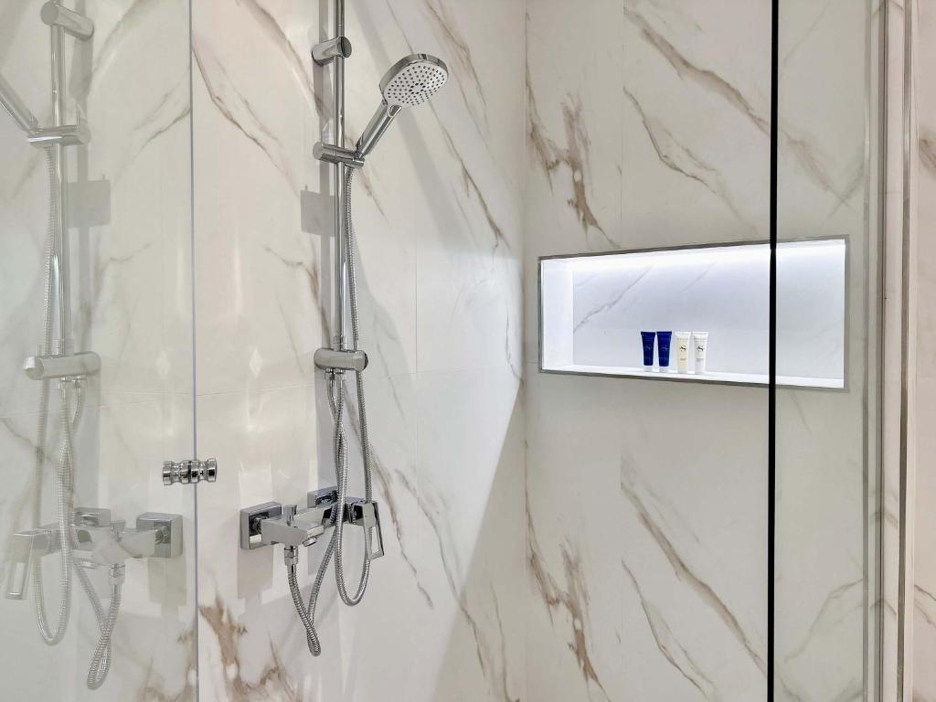 a shower in a bathroom with a glass door at Renovated Marina view apartment in Oceana in Dubai