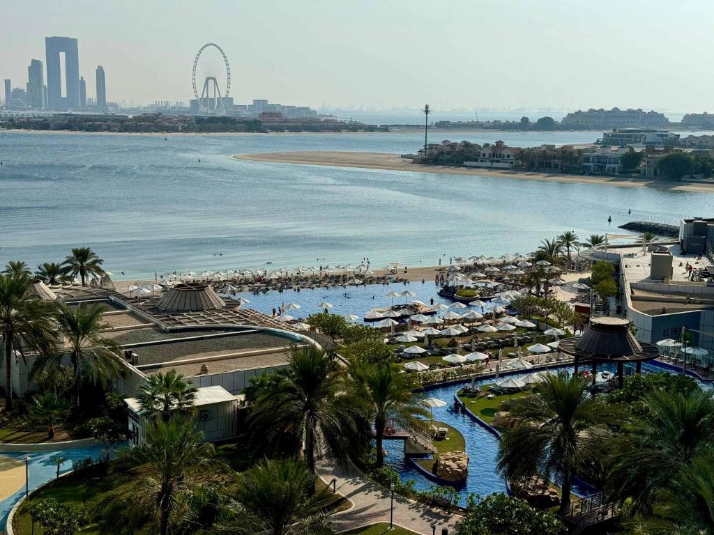 a view of a resort with a beach and a body of water at Renovated Marina view apartment in Oceana in Dubai
