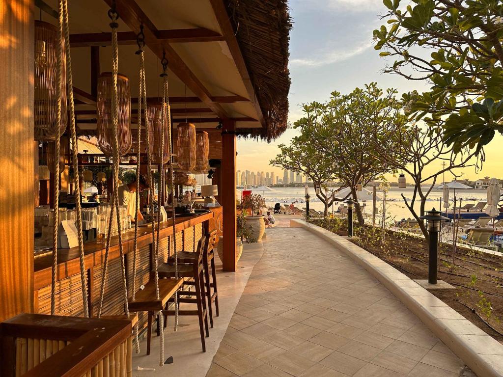 a restaurant with tables and chairs on a sidewalk at Renovated Marina view apartment in Oceana in Dubai