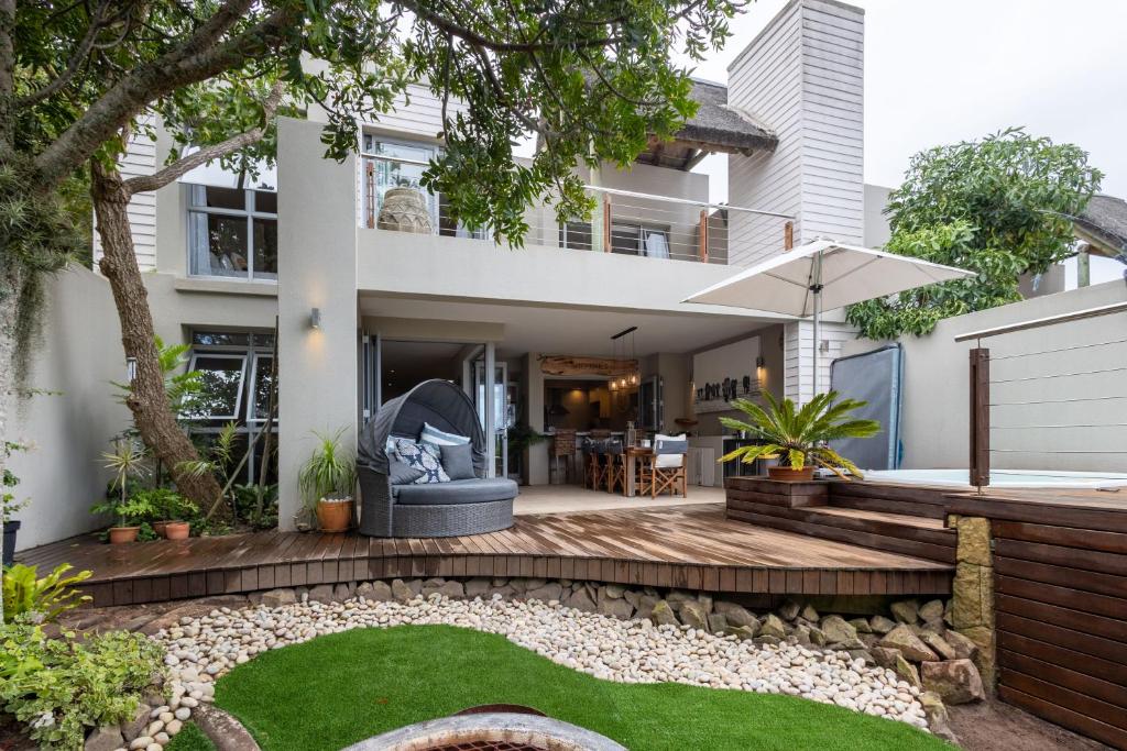 an image of a house with a backyard with a lawn at Kaya Anvi - Plettenberg Bay in Plettenberg Bay