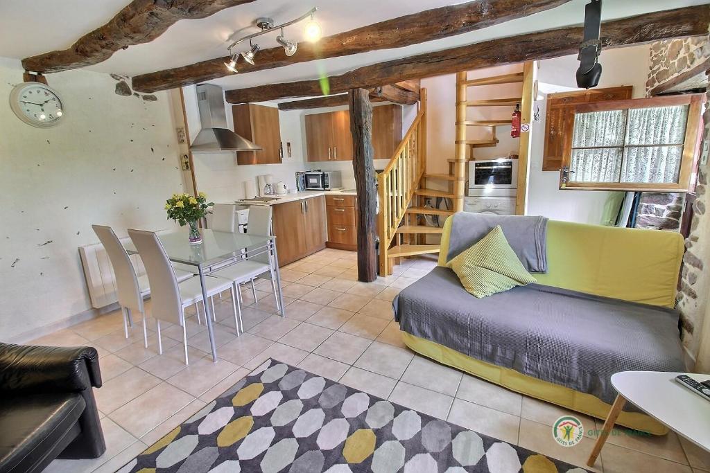 un salon avec un canapé et une table dans l'établissement Stable cottage, à Pleudihen-sur-Rance