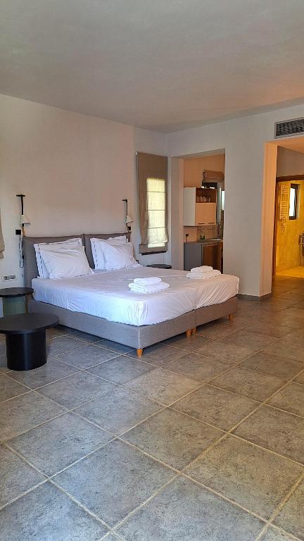 a bedroom with a large bed in a room at Margo Beach Hotel in Gythio