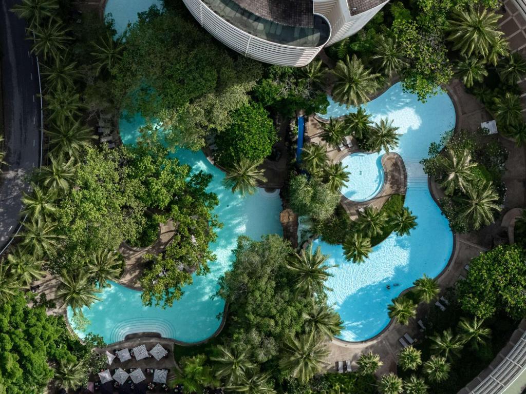 an overhead view of a pool at a resort at Pullman Phuket Karon Beach Resort in Karon Beach