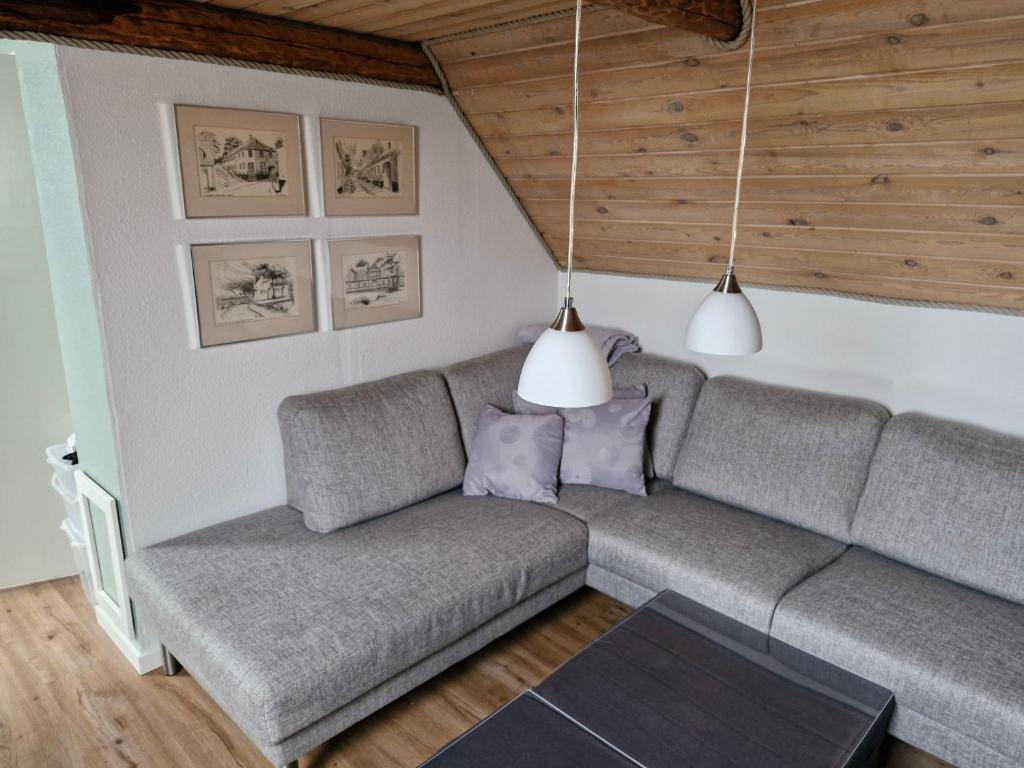 a living room with a couch and two lamps at Lækker lejlighed 1 sal in Hinge