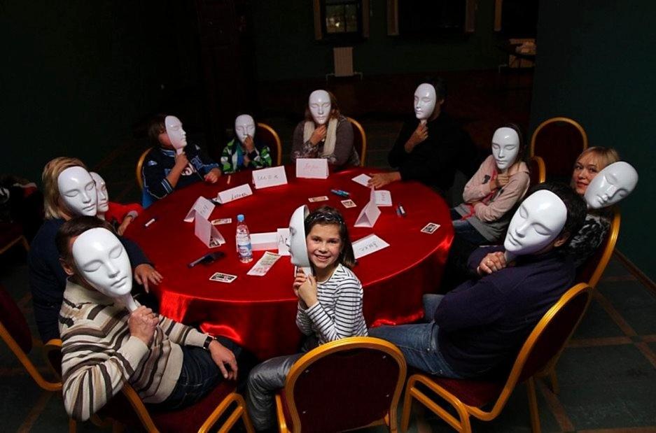 a group of people wearing masks sitting around a table at Old Baku Inn Hotel in Baku