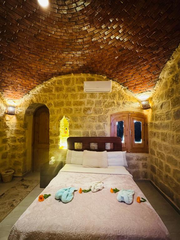 Postel nebo postele na pokoji v ubytování Pidgeon Lodge - Tunis Village