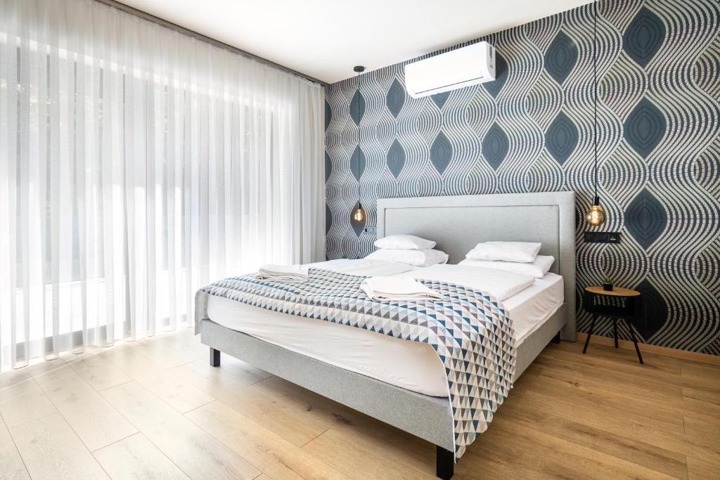 Postel nebo postele na pokoji v ubytování Optimus Residence