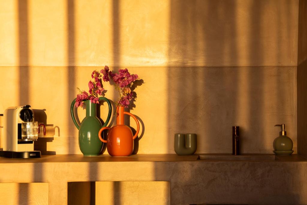 a shelf with two vases and flowers on it at Formentera Especial in La Savina