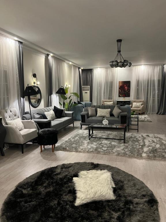 a large living room with couches and a rug at Unique villa in madinaty in Madinaty