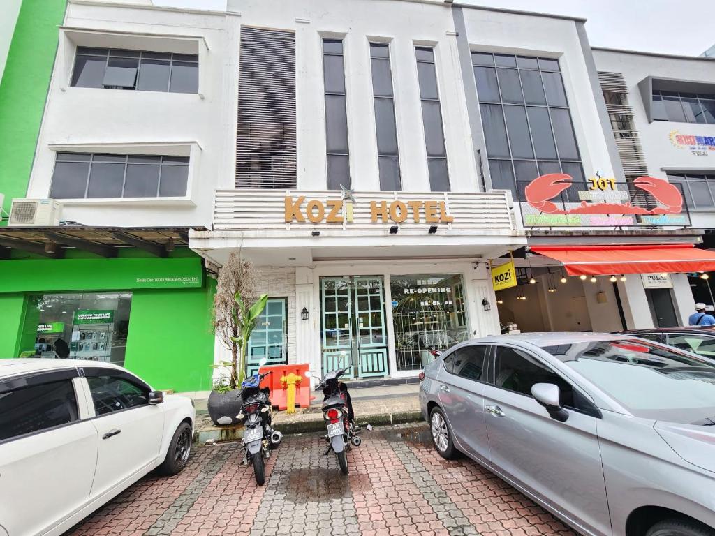 two motorcycles parked in front of a building at Kozi Hotel - Danga Bay in Johor Bahru