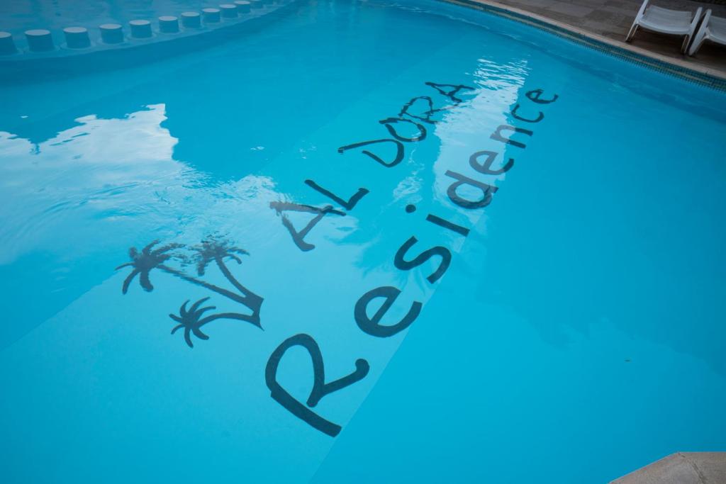 a swimming pool with the words happy holidays written on it at Al-Dora Resort Hurghada in Hurghada
