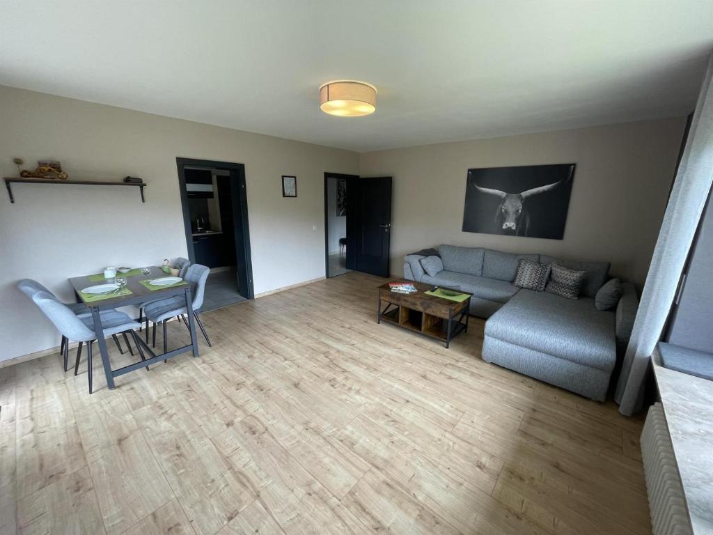 a living room with a couch and a table at Ferienwohnung Im Wiesenrain in Hausen-Wied