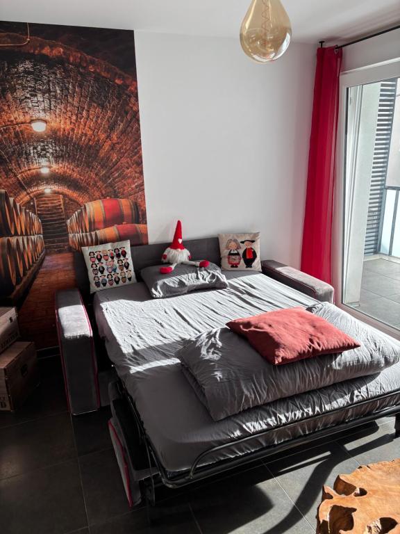 a bedroom with a bed with a santa hat on it at Le Riesling Colmar centre Charmant appartement avec terrasse et parking gratuit in Colmar