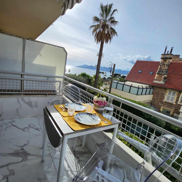 - une table sur un balcon avec vue sur l'océan dans l'établissement Victoria - Dr Picaud - 3 Pieces avec climatisation - 5 min des Plages, à Cannes