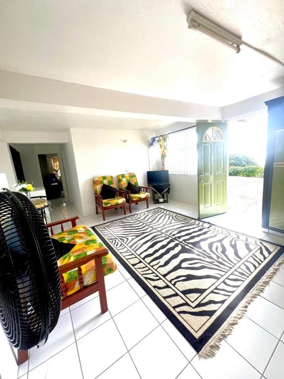 a living room with a zebra patterned rug at Castle comfort ground floor apartment in Wallhouse