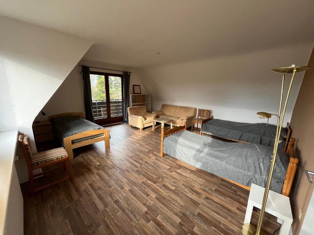 a bedroom with a bed and a table and a couch at Haus Otto in Großhansdorf