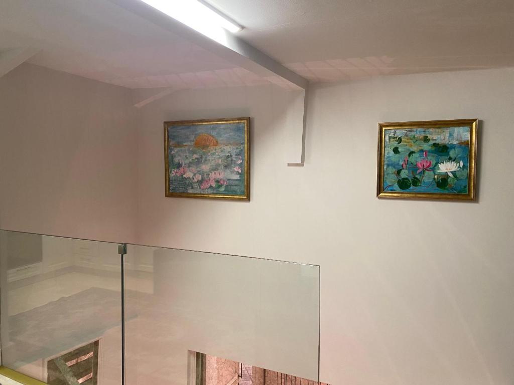 two paintings on the wall of a room at AB Residences- Private Villa Independent in Istanbul