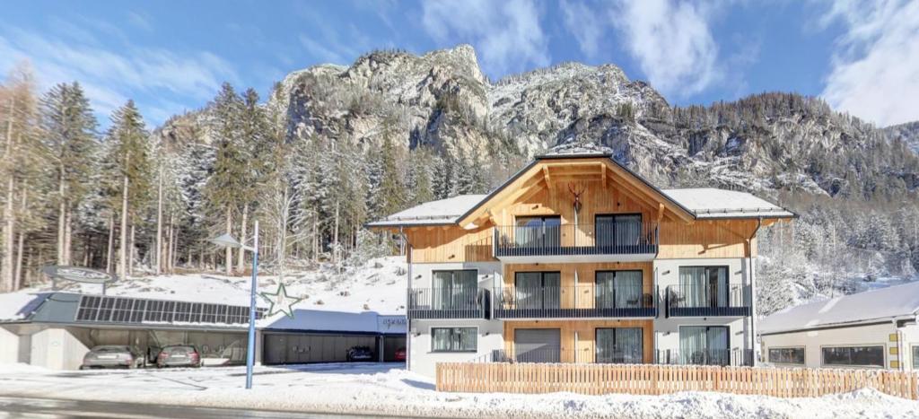 a large building with a mountain in the background at Alpenresidenz Hotel Gell in Tweng