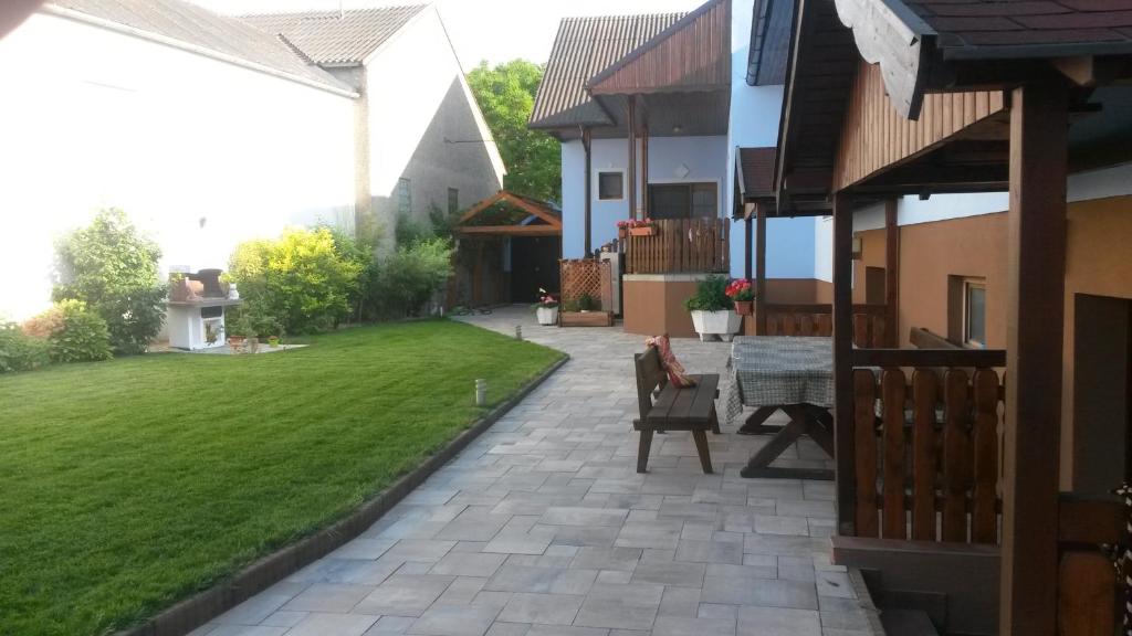 a patio with a table in the middle of a yard at Gästehaus Schneider in Illmitz