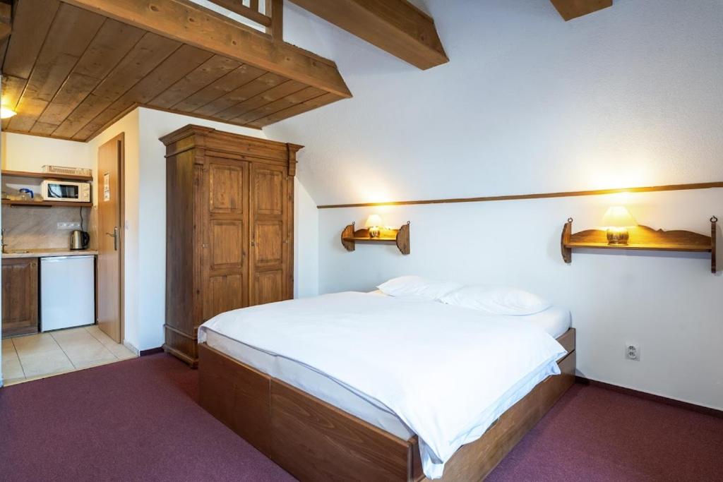 Postel nebo postele na pokoji v ubytování Apartmánový dom Vila Maroš