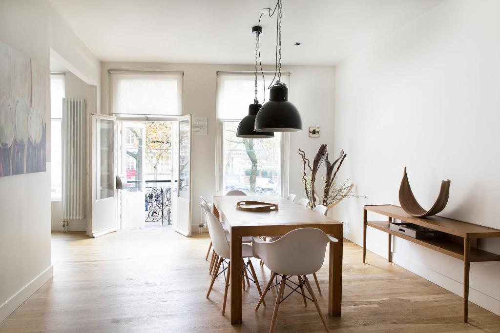 a kitchen and dining room with a table and chairs at Marnix Design: Downtown Dream in Amsterdam