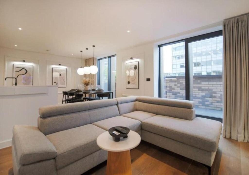 a living room with a couch and a table at Elysium by The Heim Residences in Manchester