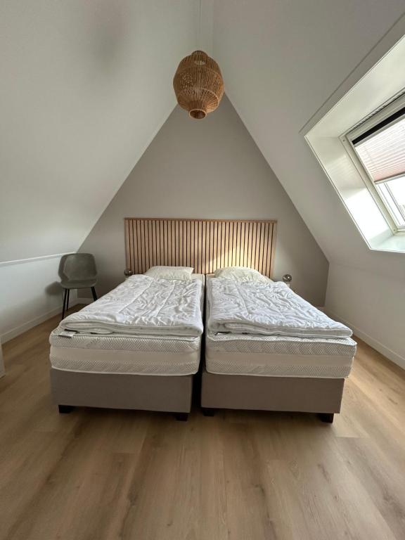 a bedroom with two beds in a attic at ' Zilten Huus Zoutelande in Zoutelande