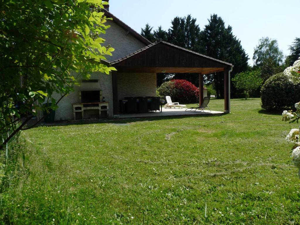 a pavilion in a garden with a grass yard at Valmy in Brantôme