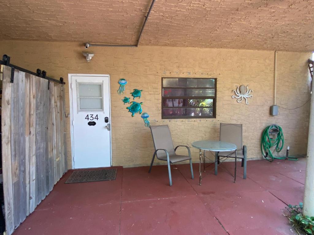 a patio with a table and chairs next to a door at Five Elements Lodge B&B with Outdoor Spa in Fernwood
