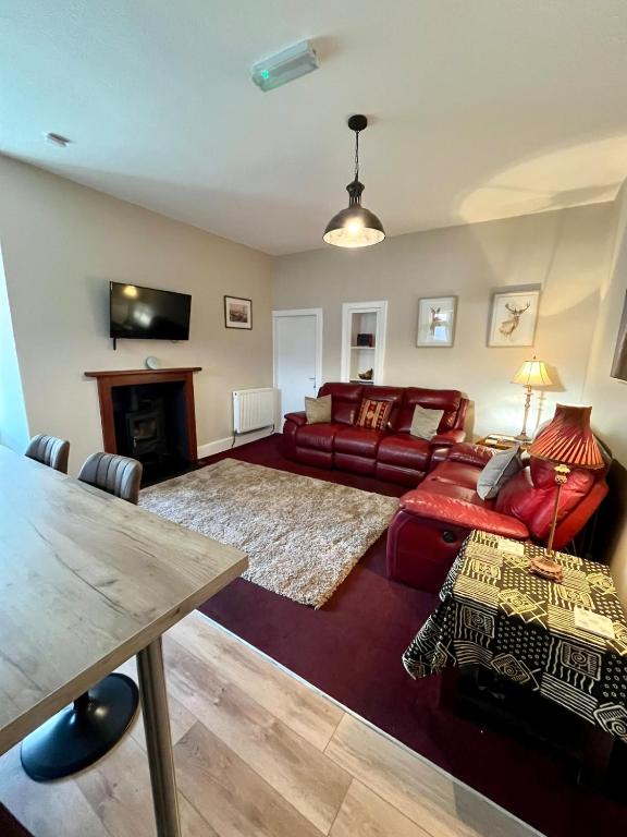 a living room with a couch and a table at The Farmhouse Snug in Spean Bridge