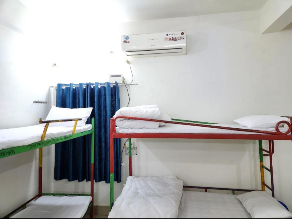 a room with two bunk beds and a radiator at BITS CAMPUs in Varanasi