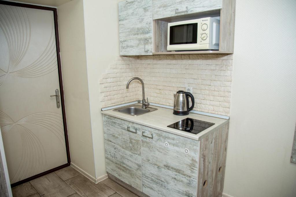 Kuchyň nebo kuchyňský kout v ubytování Sumskaya ApartHotel