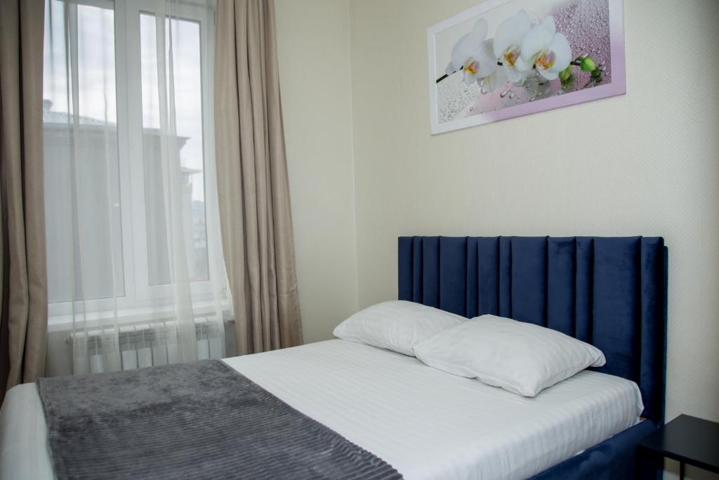Postel nebo postele na pokoji v ubytování Sumskaya ApartHotel