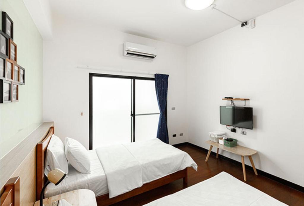 Postel nebo postele na pokoji v ubytování Chenting Yiyu B&B