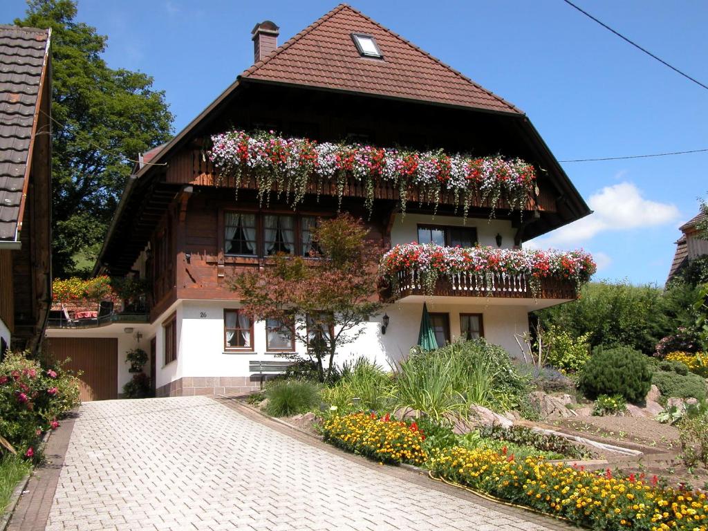 a house with flower boxes on the side of it at Oberbauernhof - Wohnung "Stübleberg" -- Moderne FeWo im schönen Schwarzwaldhaus in Gutach