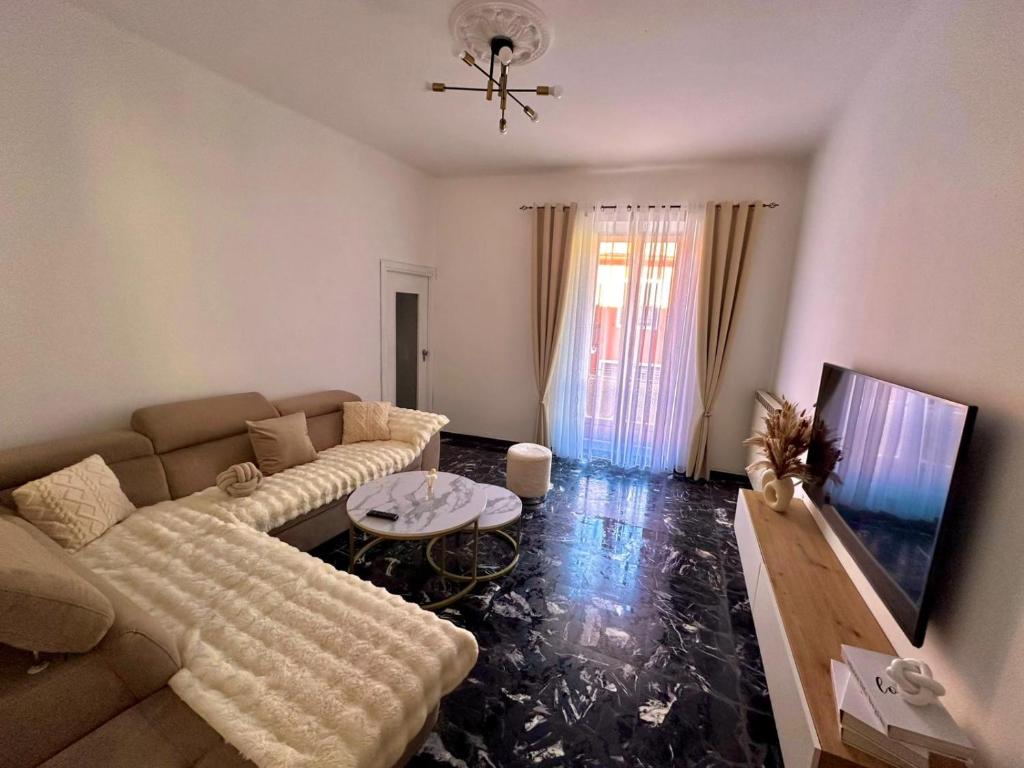 a living room with a couch and a flat screen tv at Ca di nonni in Ortovero