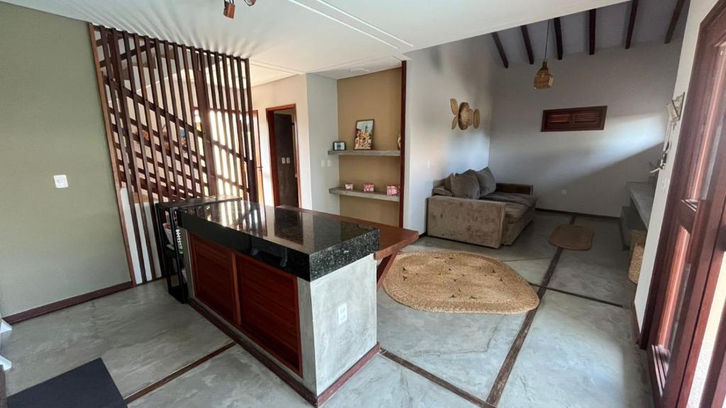 a living room with a counter and a couch at Casa Vivienda - Barra Grande in Barra Grande
