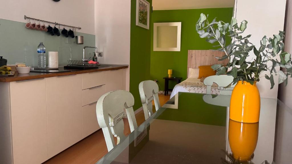 a kitchen with an orange vase on a table with chairs at Beach LOFT Tabaiba in Tabaiba