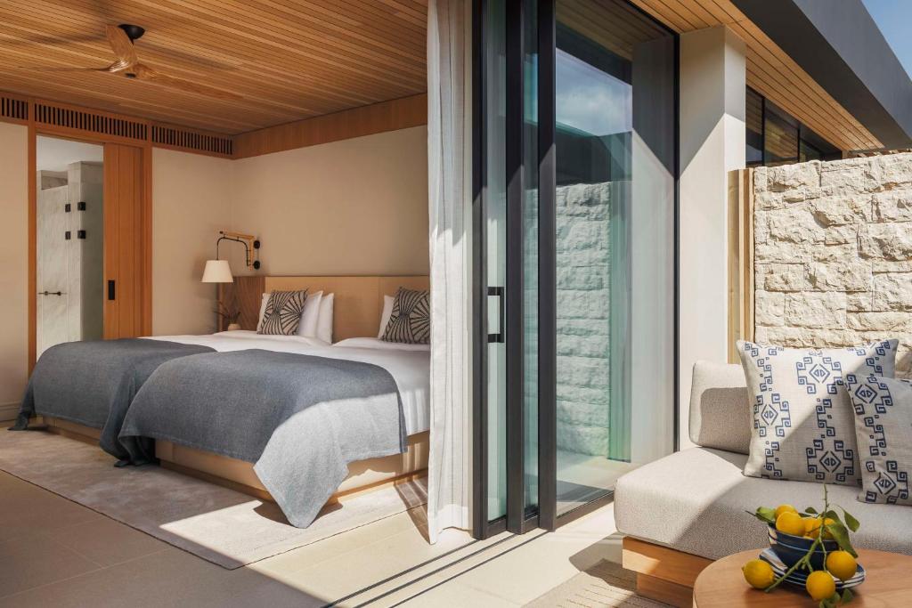 a bedroom with a large bed and a window at One&Only Aesthesis, Athens in Athens