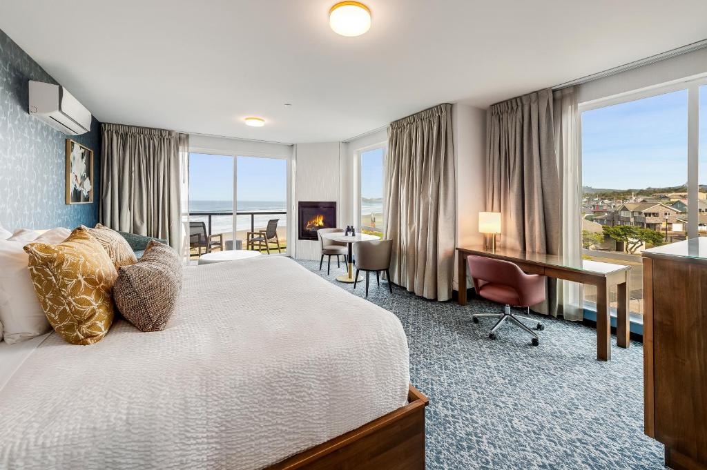 a hotel room with a bed and a desk and windows at Allred Hotel in Newport